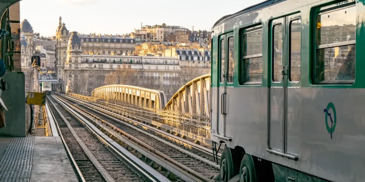 Un tren del metro de París, Francia, avanza por las vías al atardecer.