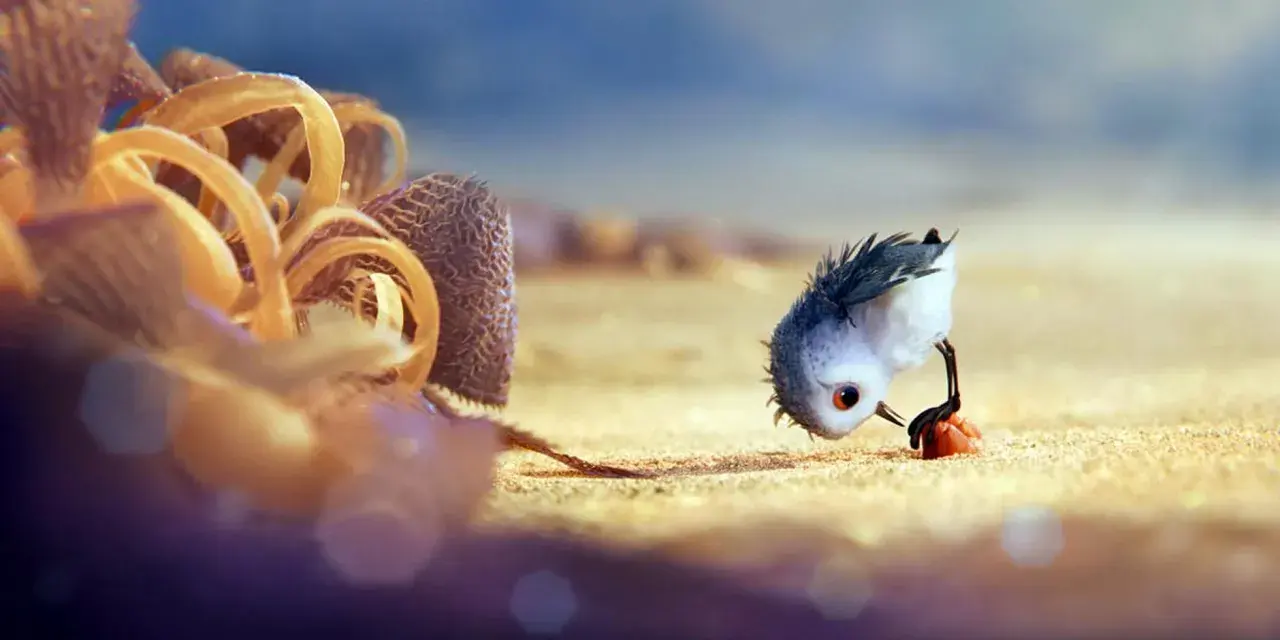 Un pulcino spaventato cerca cibo sulla spiaggia, un'immagine che cattura il significato del cortometraggio "Piper" sulla crescita e il coraggio.