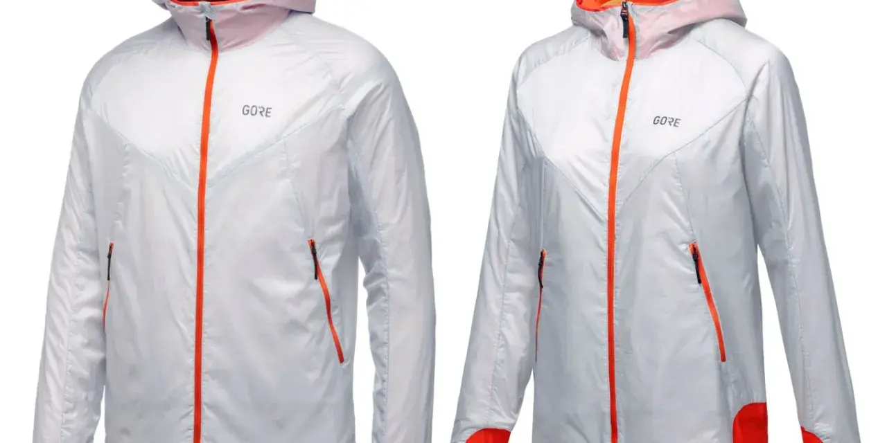 Zwei leichte, weiße Laufjacken mit orangefarbenen Reißverschlüssen und Akzenten. Perfekt für jedes Wetter dank GORE-TEX INFINIUM.
