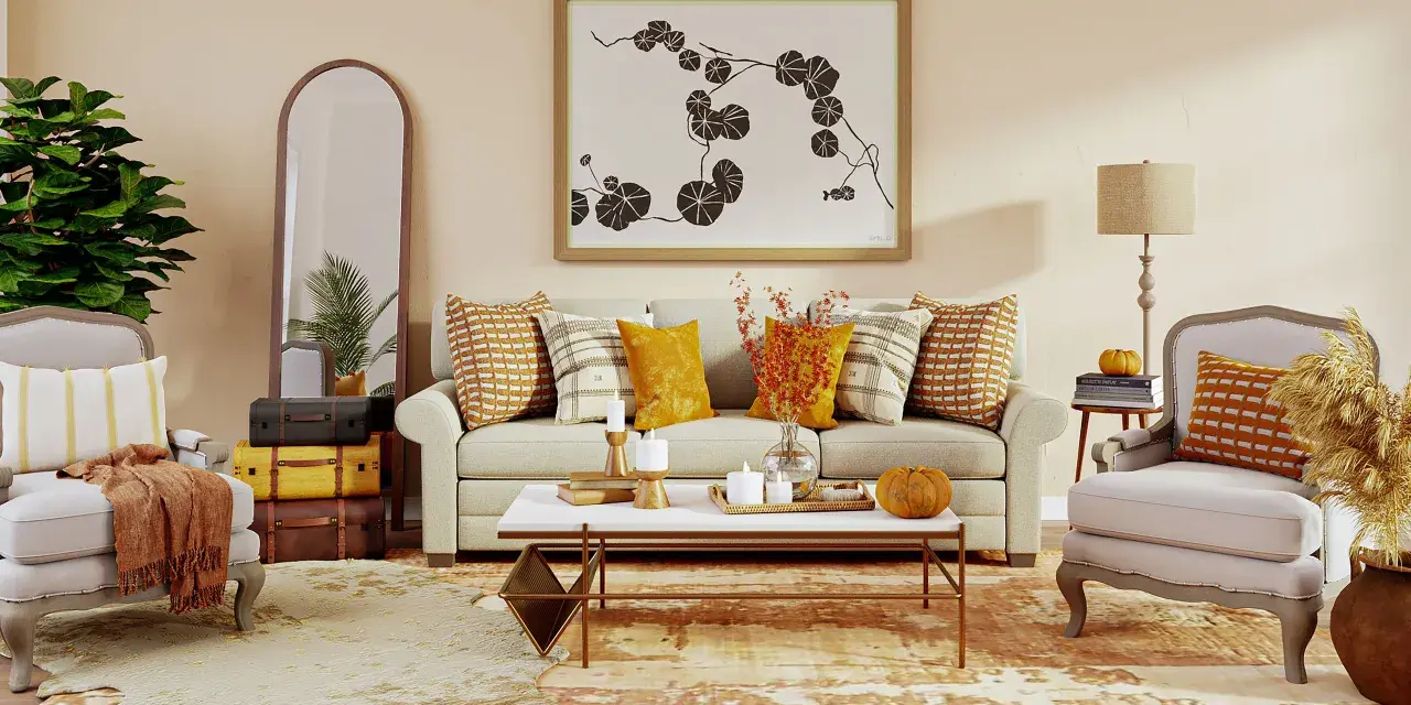 Acogedor salón con sofá, sillones y mesa de centro. Destaca una **gama colores cálidos** en cojines, mantas y decoración otoñal.
