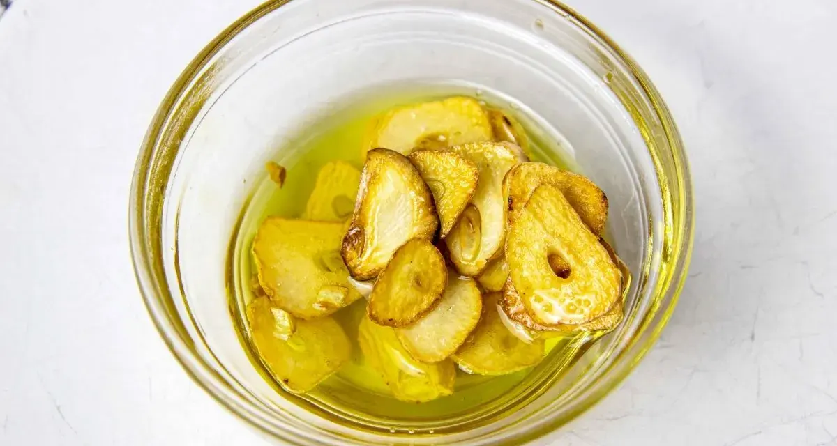 Ajo laminado y dorado en aceite de oliva, listo para añadir sabor a tu rape a la plancha.