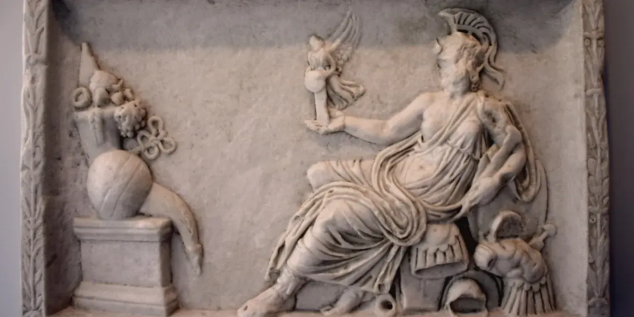 A marble relief depicting a seated figure, possibly a goddess, holding a winged victory. This scene reflects the rich tapestry of Roman paganism, with symbolic offerings and divine representation.