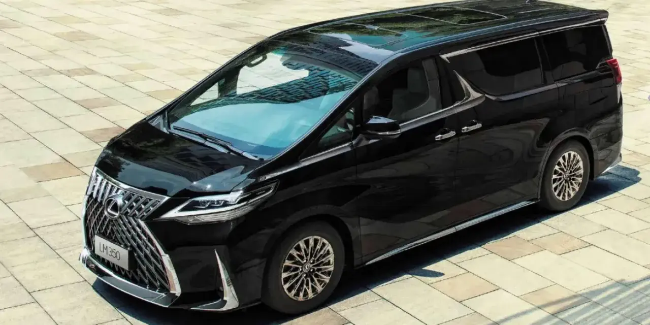 Elegancki, czarny Lexus LM 350h lśni na tle jasnej kostki brukowej.
