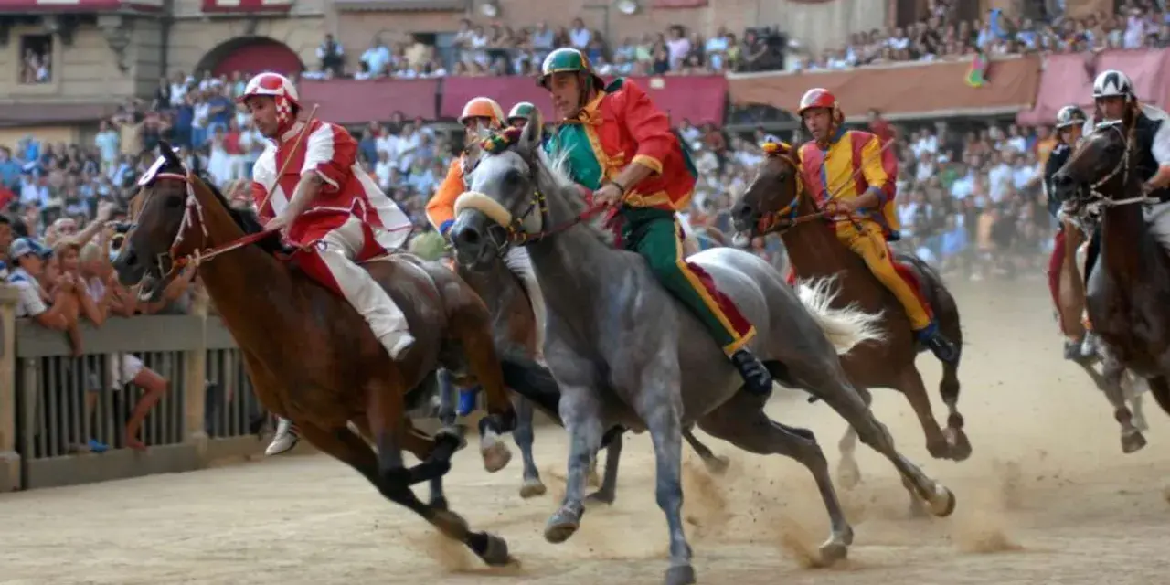 Jockeys in colorful silks race horses during the Palio di Siena. Dust flies as the horses thunder across the track, a thrilling spectacle of the historic siena horse race.