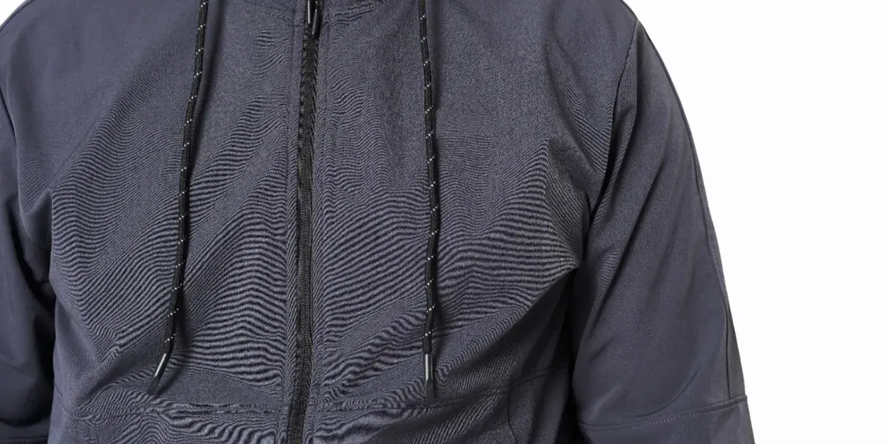 Szara kurtka softshell z zamkiem i sznurkami. Dowiedz się, jak prać softshell, by zachował swoje właściwości.