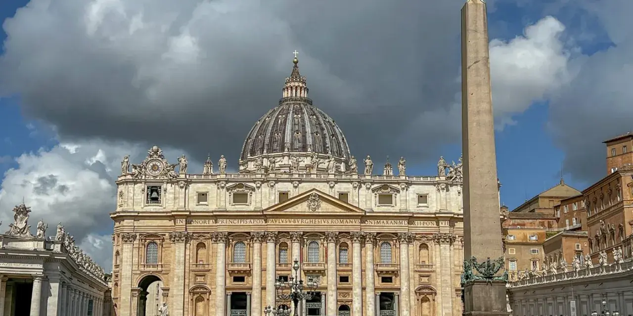 St. Peter's Basilica, one of the most beautiful churches in Rome, stands majestically with its dome and an ancient obelisk in the foreground.