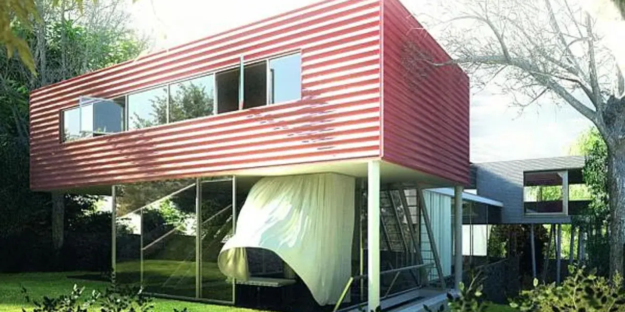 Villa Dall'Ava, une maison moderne aux lignes épurées, avec un étage supérieur rouge à rayures blanches, suspendu au-dessus d'un rez-de-chaussée vitré.