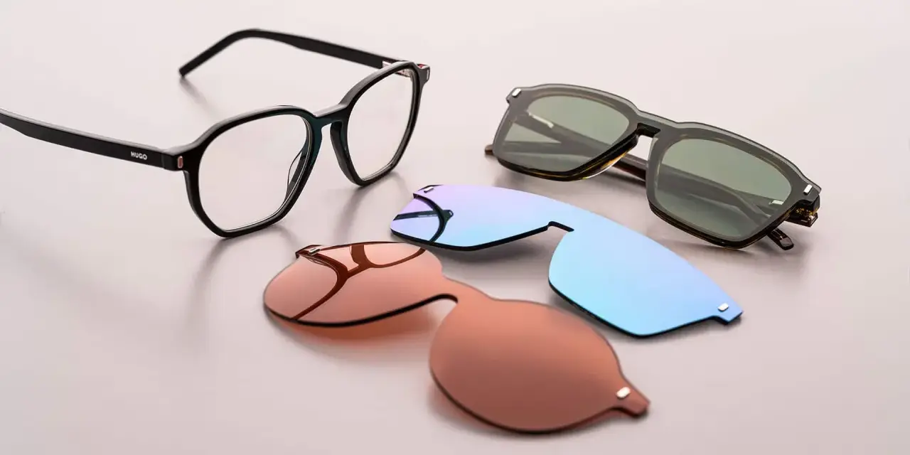 Occhiali da vista Hugo Boss AG con lenti intercambiabili: una montatura nera, lenti da sole marroni, azzurre e verdi.