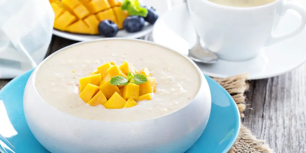 Pyszny deser z mango, jagodami i kawą. Ten mango smak to idealny początek dnia.