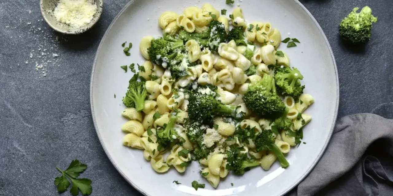 Pasta con brócoli cremosa, espolvoreada con queso rallado y perejil fresco. Un plato sencillo y delicioso.