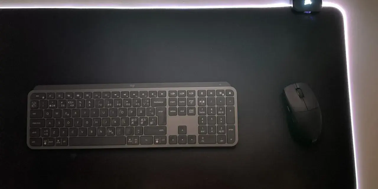En svart musmatta XL med RGB-belysning, ett trådlöst tangentbord och en mus.