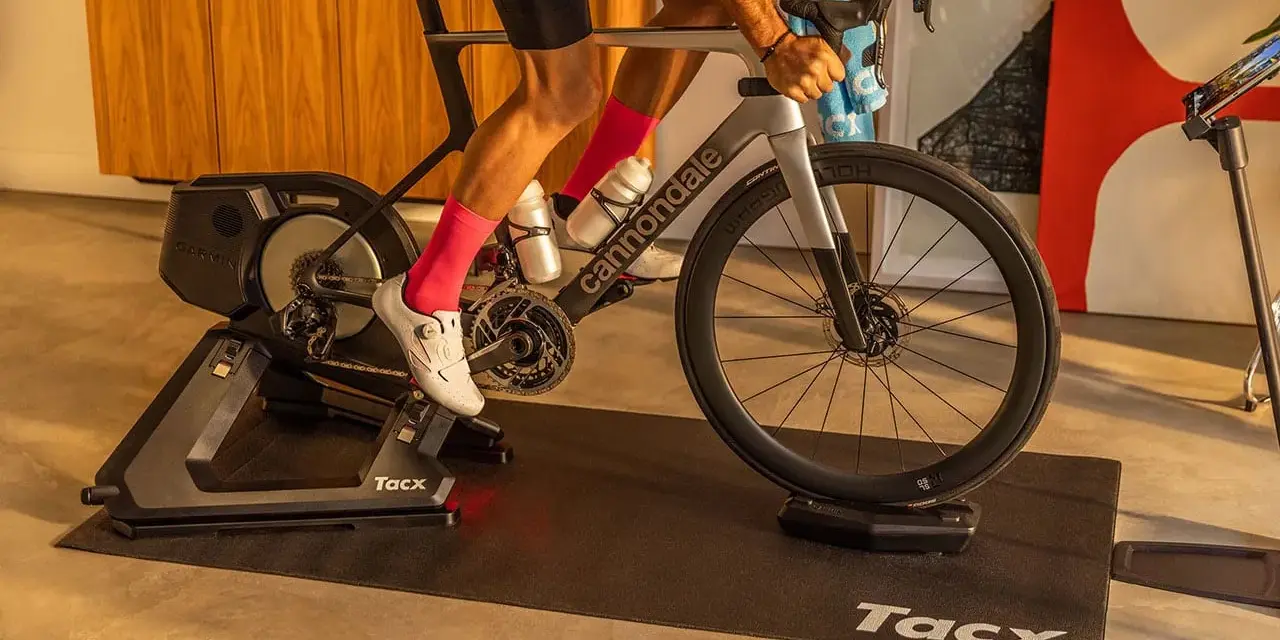 A cyclist trains indoors on a Tacx bike trainer, a device that allows you to ride your bicycle stationary.