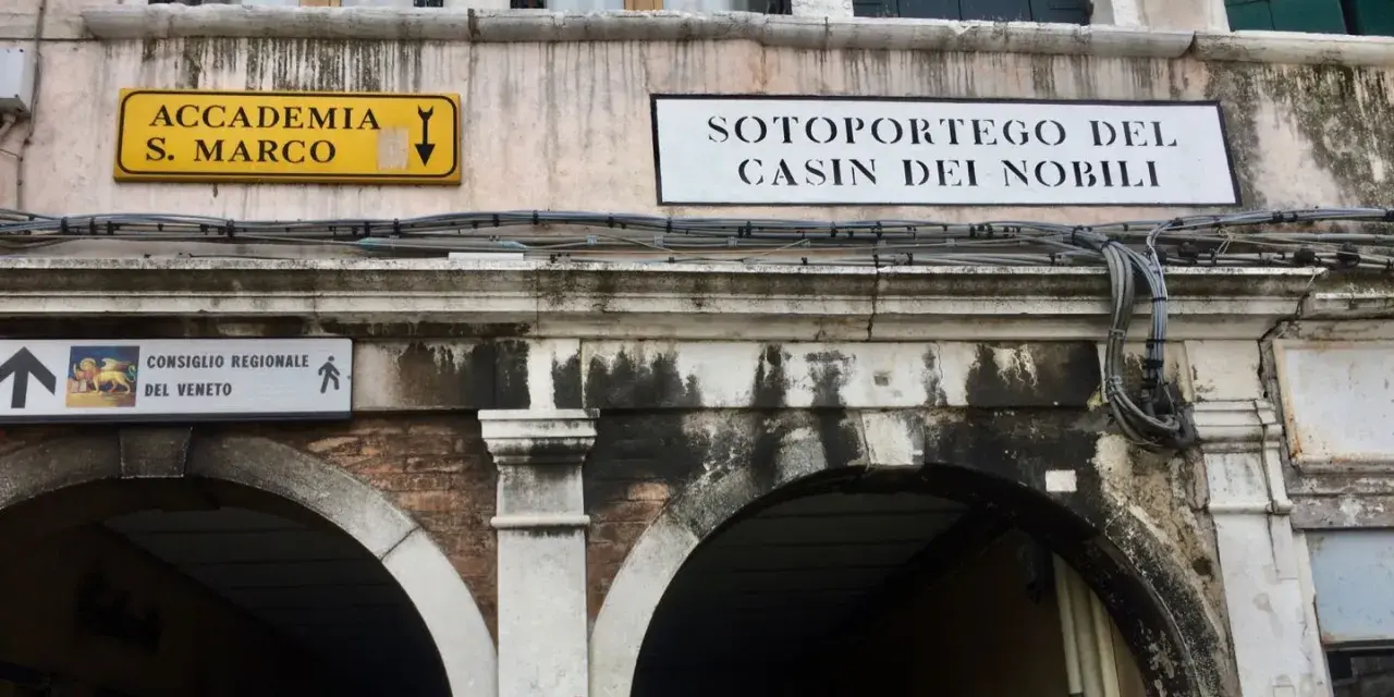 Segnali stradali a Venezia indicano "Accademia S. Marco" e "Sotoportego del Casin dei Nobili".