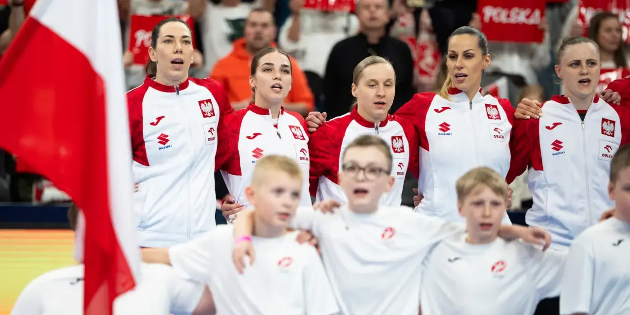 Drużyna Polski podczas mistrzostw Europy w piłce ręcznej kobiet. Kibice z transparentami "Polska" dopingują zawodniczki.