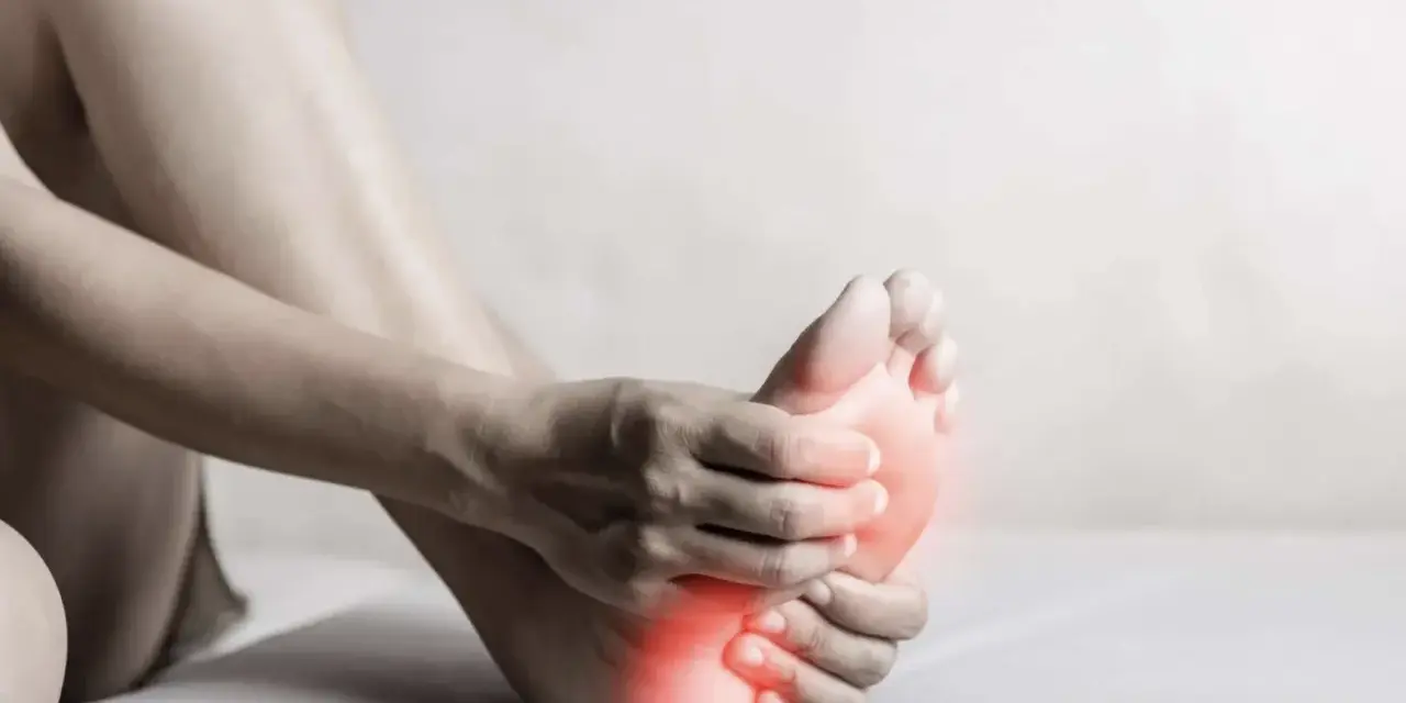 A person holds their foot, with red highlights indicating discomfort. This image evokes the feeling of needing natural foot detox.