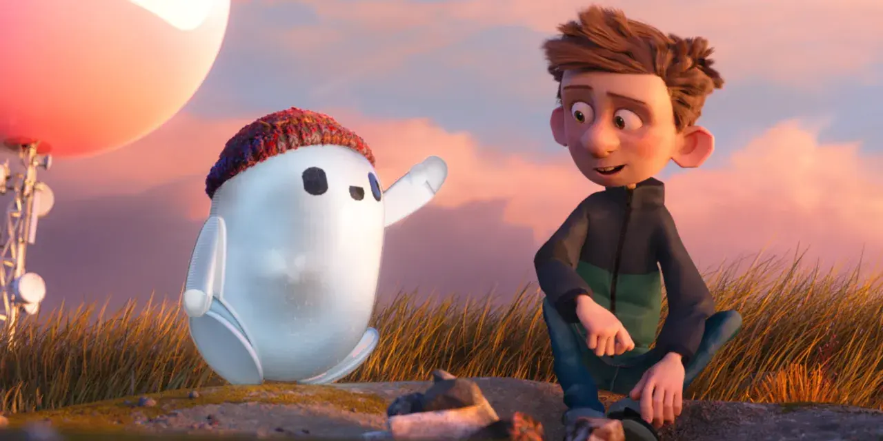 Chłopiec i robot Ron, bohater jednej z warner bros bajek, siedzą na wzgórzu podczas zachodu słońca.