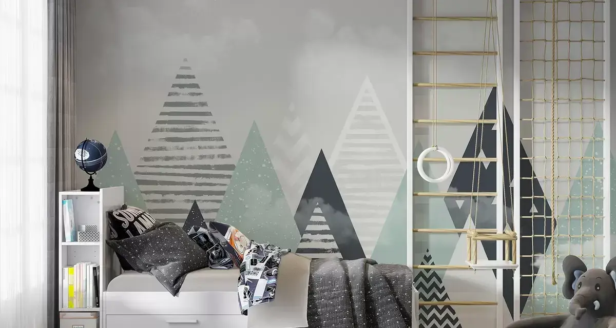 Habitación infantil con pared que simula pintar montañas, cama, estantería y zona de juegos con columpio.