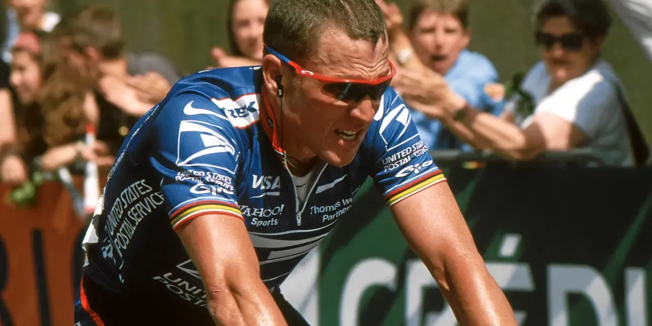 Lance Armstrong, in his USPS jersey, strains during a race, a stark image given how Lance Armstrong cheated his way to victory.