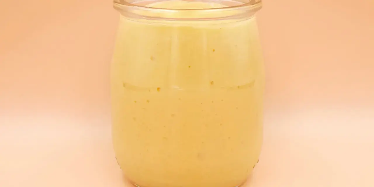 Gęsty, kremowy mango lassi w szklanym słoiku, gotowy do orzeźwiającego łyku.