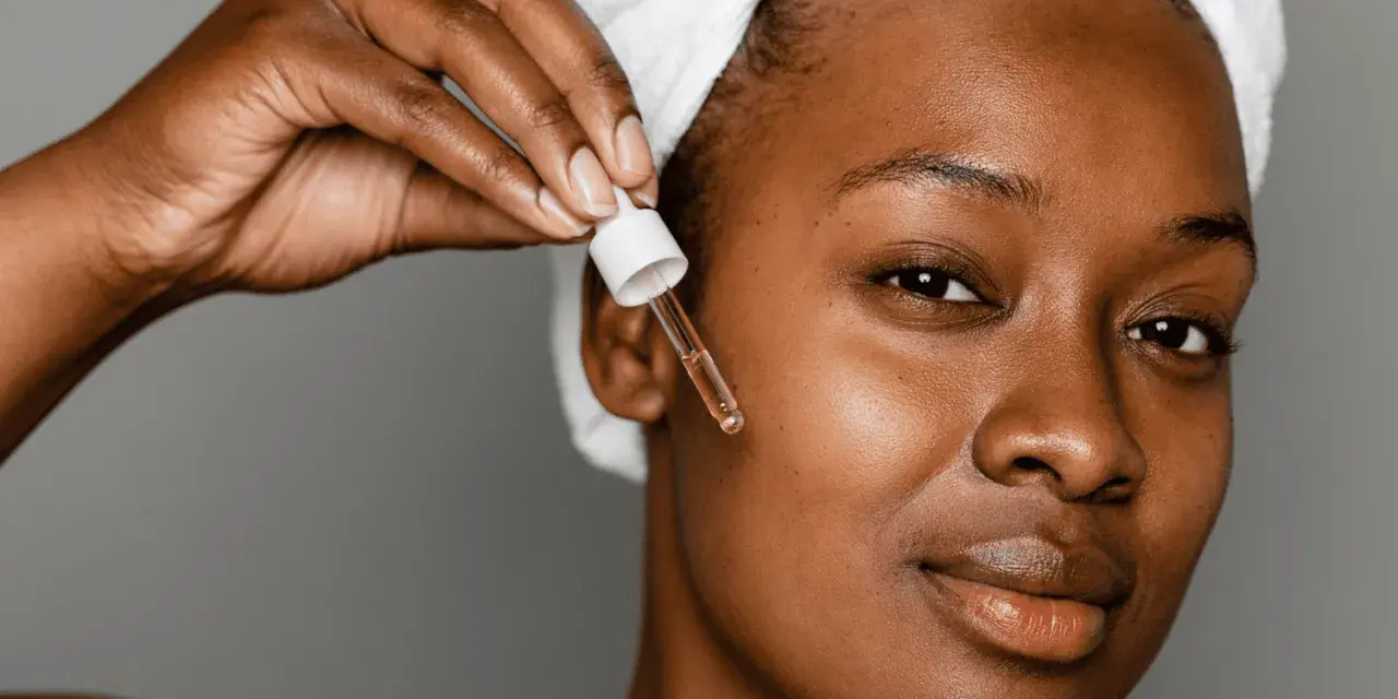 A woman applies a serum with peptides for acne, a step in her skincare routine.