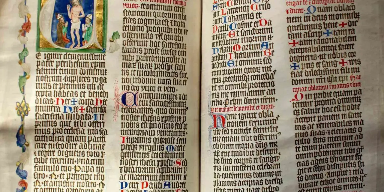 First Sunday of Advent readings from an illuminated manuscript. Jesus is depicted in the initial letter, with ornate borders and calligraphy.