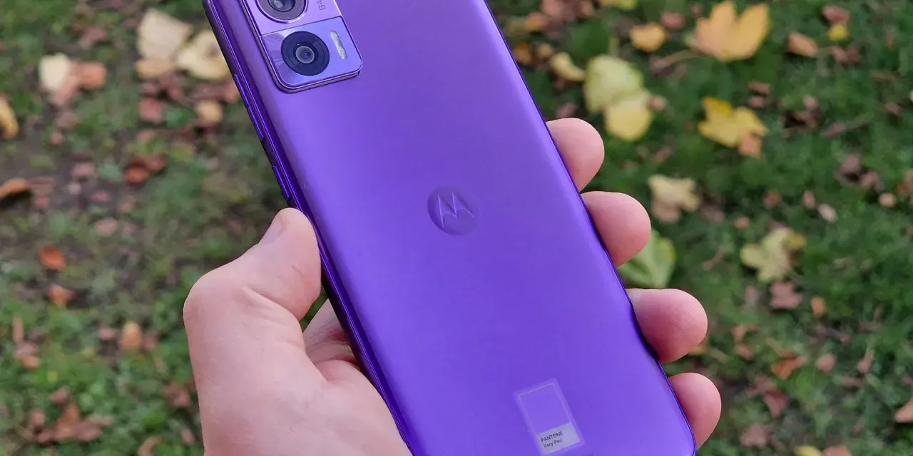 Fioletowy Motorola Edge 30 Neo Play w dłoni, na tle jesiennych liści. Idealny do uchwycenia każdej chwili.