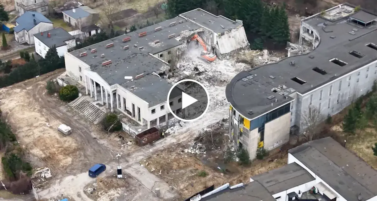 Ruiny hotelu Murat w Redzie, gdzie trwa rozbiórka. Maszyna budowlana niszczy budynek, odpowiadając na pytanie, dlaczego upadł hotel Murat w Redzie.
