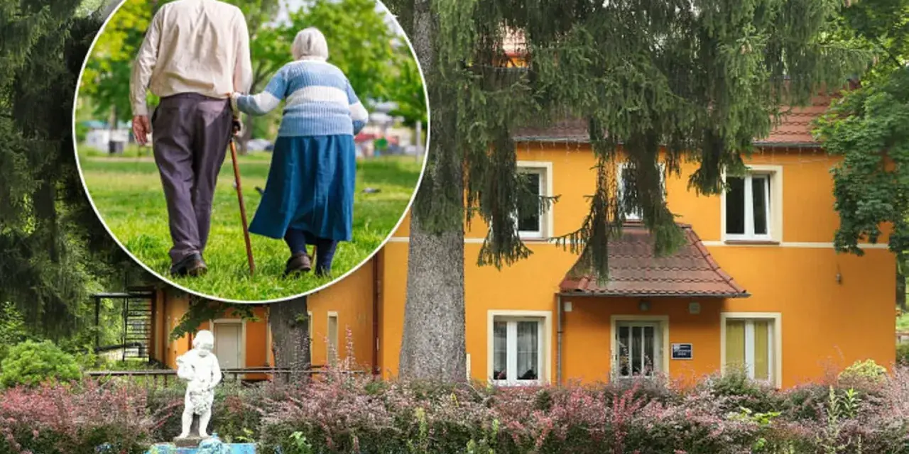 Spacer po parku przy sanatorium w Przerzeczynie Zdroju. Starsza para, wspierając się laską, cieszy się spokojnym popołudniem.