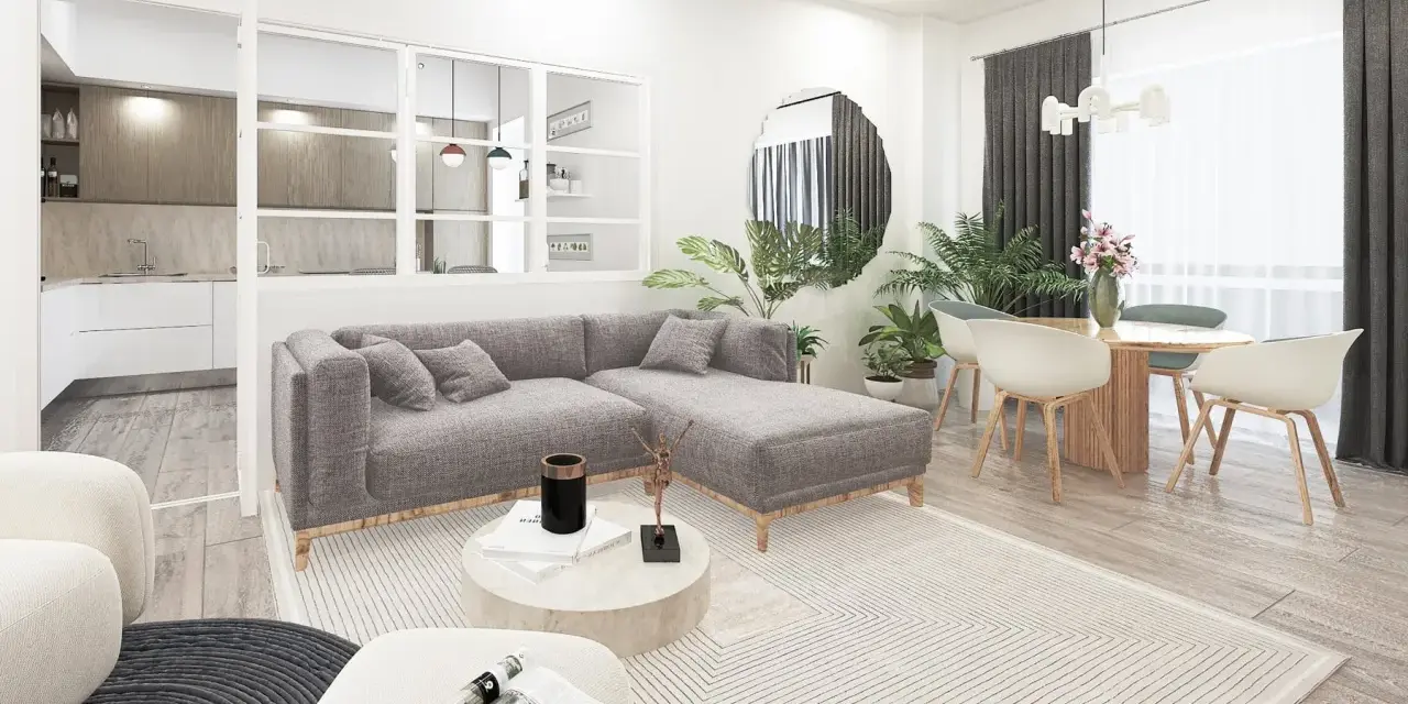 Soggiorno moderno con divano grigio, tavolino rotondo e cucina a vista. L'arredamento minimalista e i toni neutri evocano un caldo **stile nordico**.