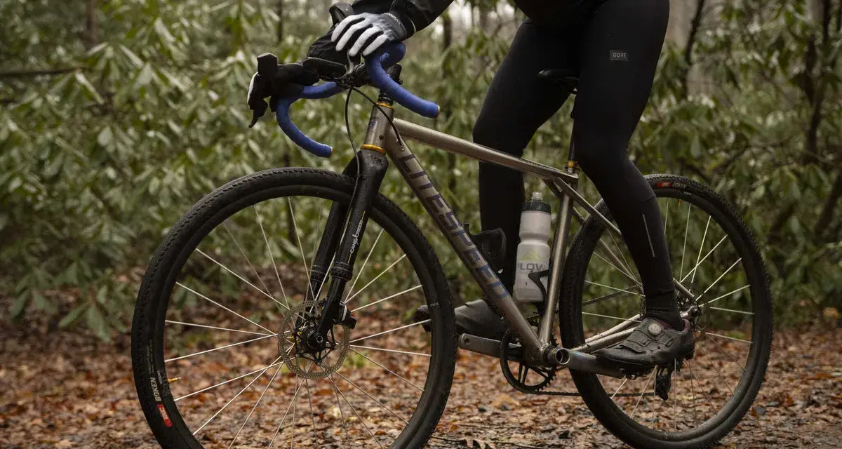 Cyclist adjusting saddle height to prevent calf pain.