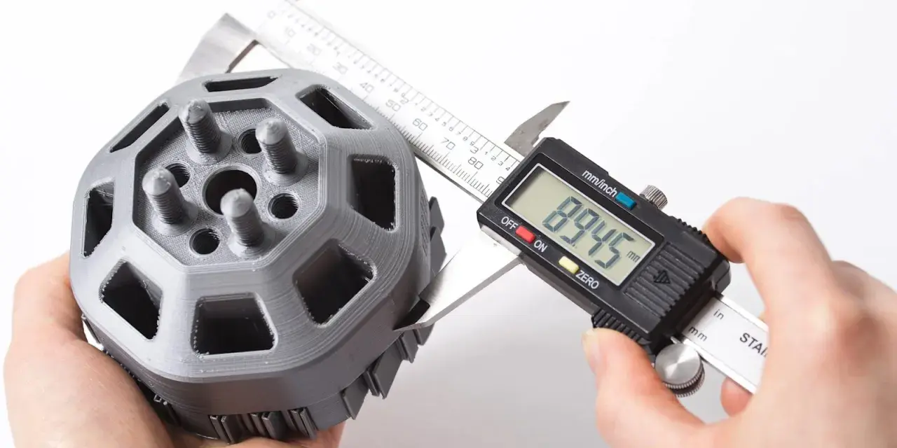 A caliper measures a 3D printed part, showcasing the precision of 3D printing.