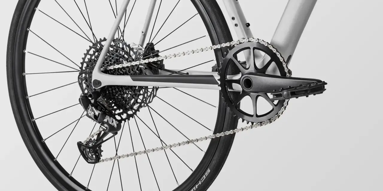 Close-up of a modern MTB drivetrain, featuring a SRAM rear derailleur, a wide-range cassette, and a single-chainring crankset.