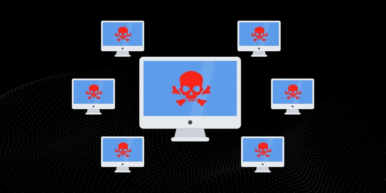 Komputery z czerwonymi czaszkami na ekranach, symbolizujące atak DDoS.