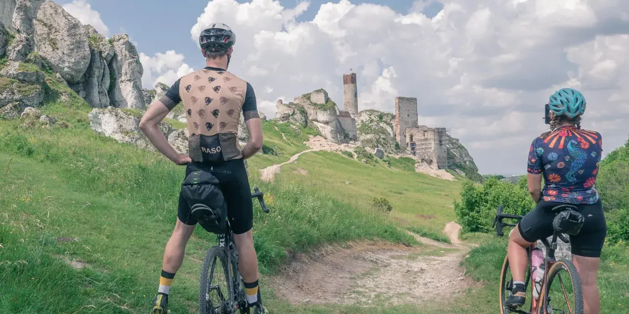 Rowerzyści podziwiają ruiny zamku na Szlaku Orlich Gniazd. Malowniczy krajobraz Jury Krakowsko-Częstochowskiej.
