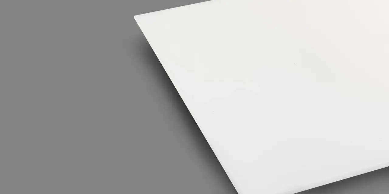 A white sheet of plexiglass is shown on a gray background. This material is known for being heat resistant, making it suitable for various applications.