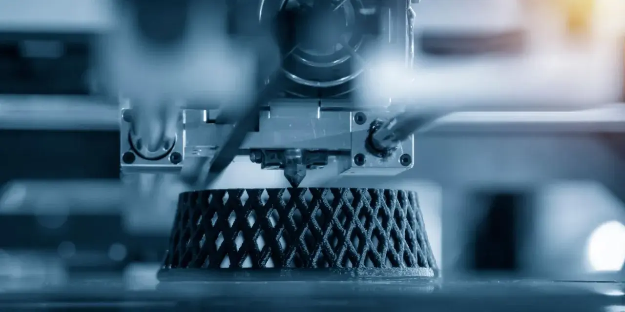 Close-up of an advanced 3D printing machine creating a complex, lattice-like object layer by layer.