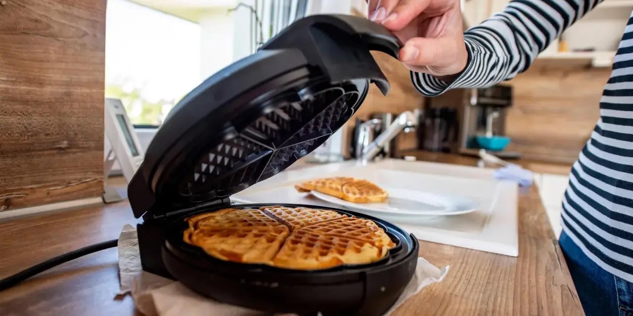 Nach dem Genuss von Waffeln wird das Waffeleisen gereinigt.