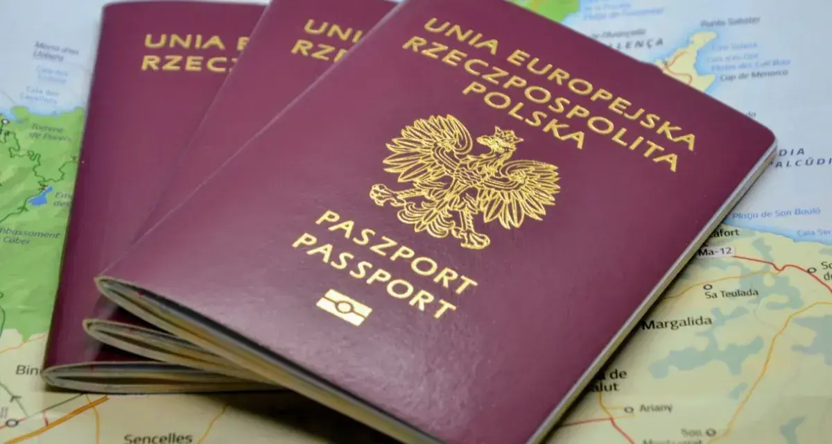 Trzy polskie paszporty leżą na mapie. Zastanawiasz się, ile trwa wyrobienie paszportu?