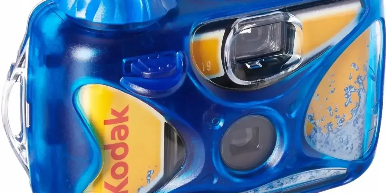 Niebieski aparat jednorazowy Kodak z żółtą wkładką. Idealny do uchwycenia letnich wspomnień.