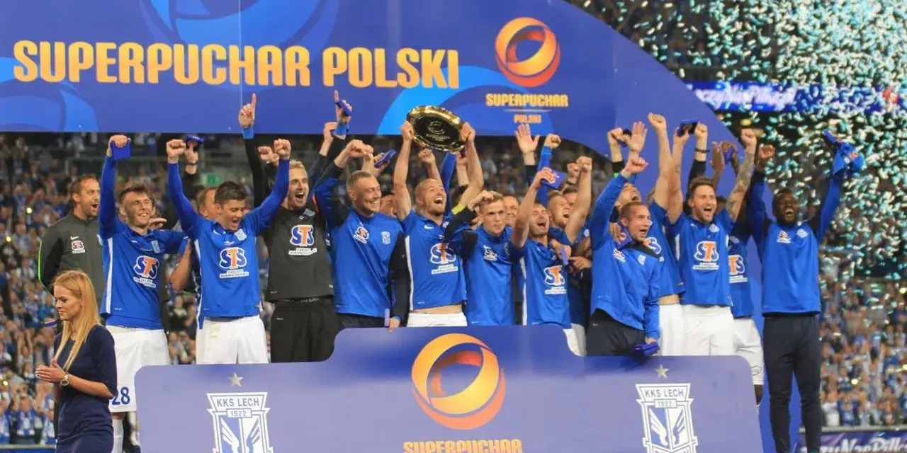 Drużyna w niebieskich strojach świętuje zdobycie Superpucharu Polski, unosząc trofeum i ciesząc się z wygranej wśród konfetti.