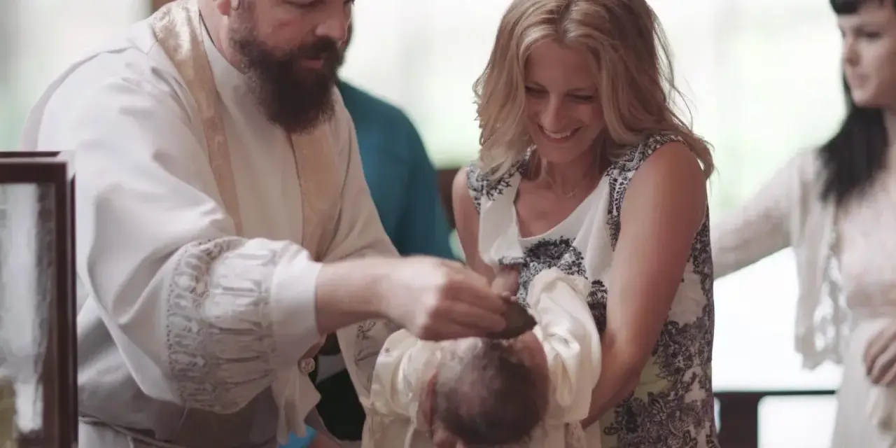 A priest performs a baptism, pouring water on a baby's head. The mother smiles, holding her child. This image captures the sacred moment of how to baptize someone.