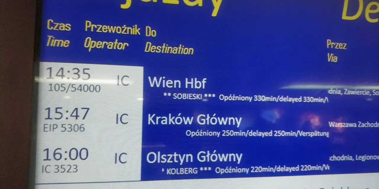 Tablica odjazdów pociągów PKP Intercity z informacjami o opóźnieniach.