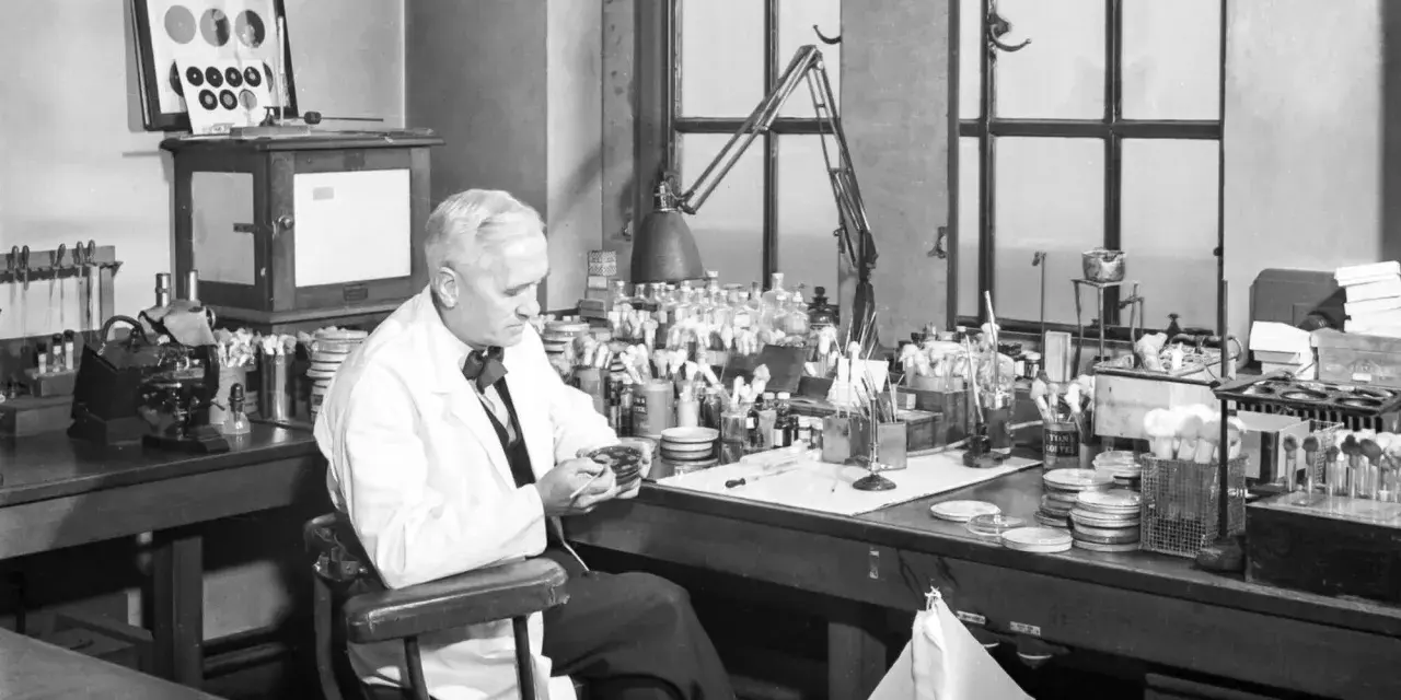 Un scientifique examine une boîte de Pétri, rappelant la découverte de la pénicilline, une avancée majeure dans l'histoire de la médecine, à l'image des travaux de Pasteur.