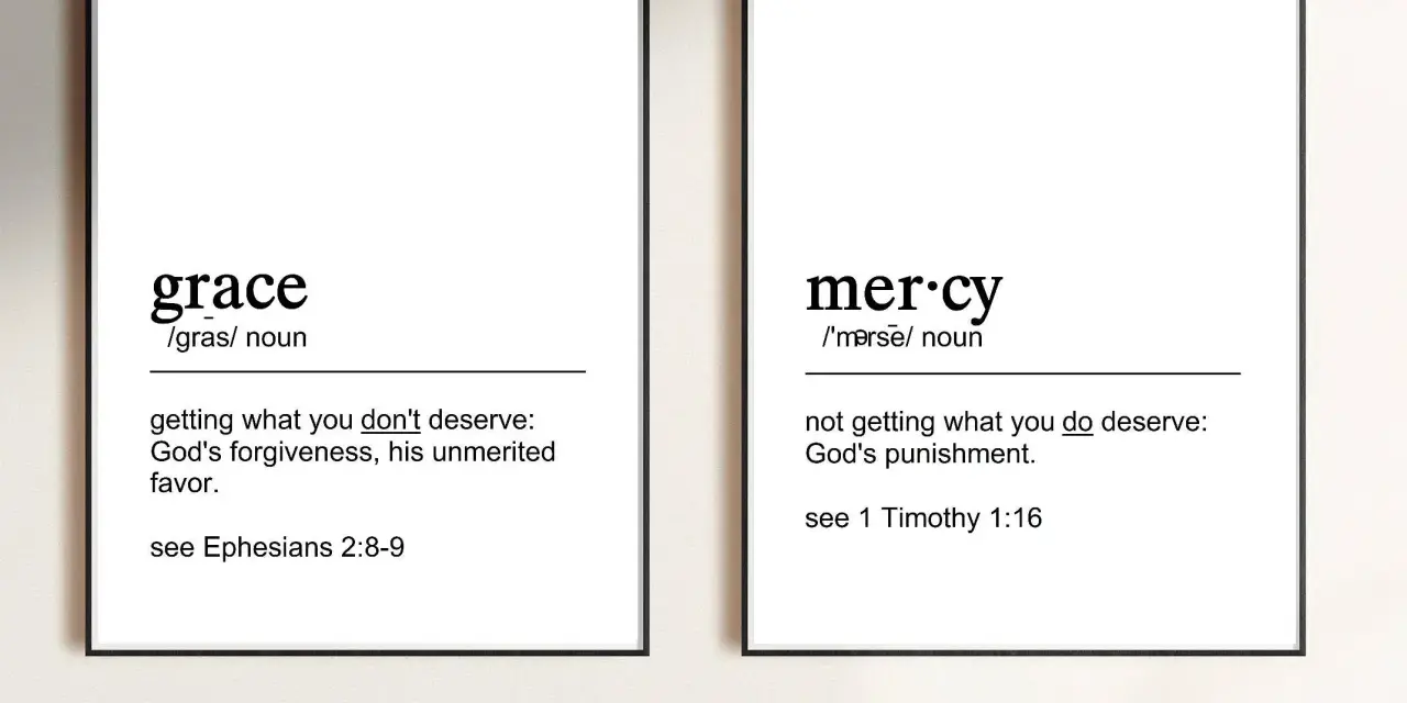 Two framed prints define "grace" as unmerited favor and "mercy" as not getting what you deserve, illustrating the contrast between grace vs mercy.