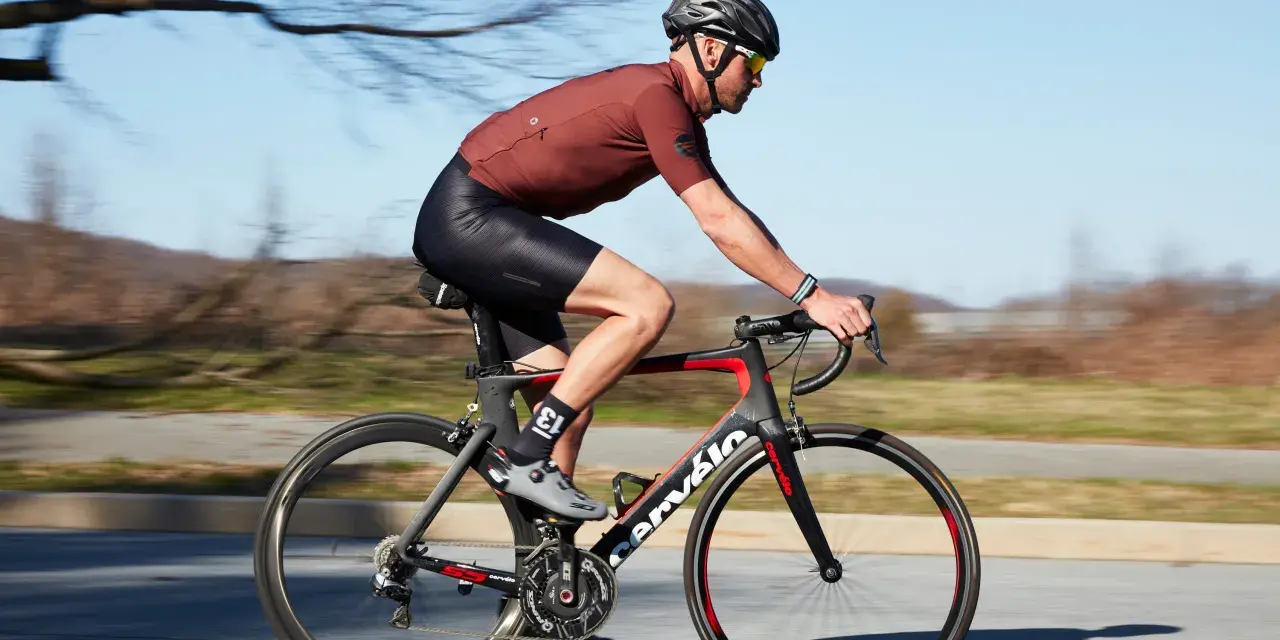 Cyclist in motion, demonstrating optimal road bike seat height for efficient pedaling.