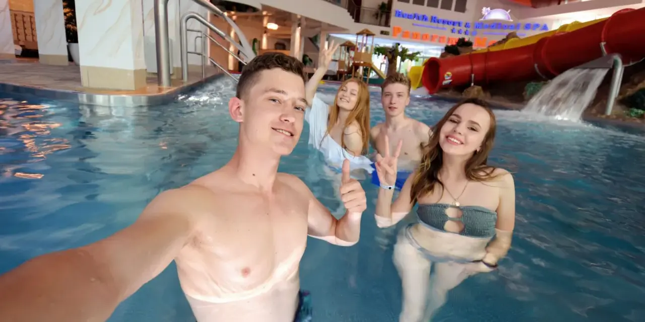 Grupa młodych ludzi cieszy się wodnym szaleństwem w aquaparku. Czy wiek ma znaczenie, by wynająć hotel i spędzić tu czas?