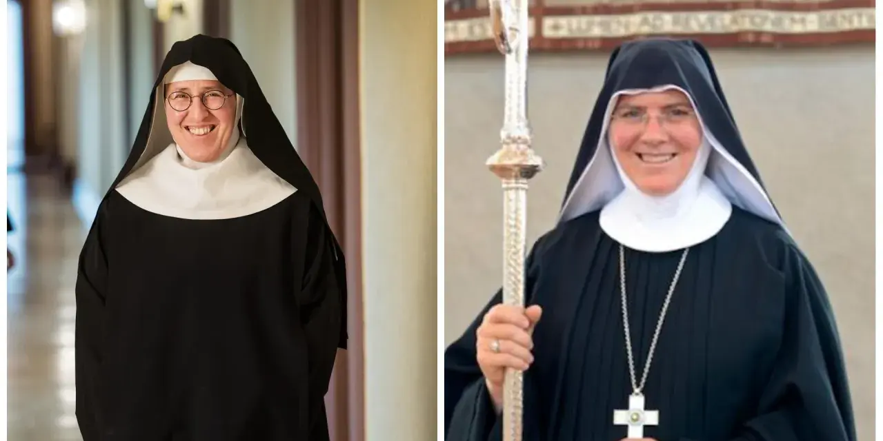 Two smiling nuns in traditional black habits and white wimples. This is what Catholic monks wear, along with a cross necklace and a staff.