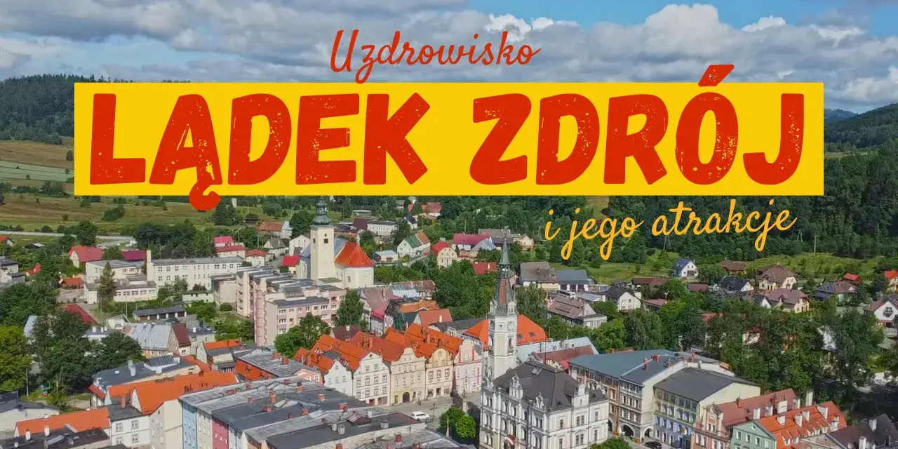 Widok na Lądek Zdrój i jego atrakcje. Miasto z kolorowymi kamienicami, kościołem i zielonymi wzgórzami w tle.
