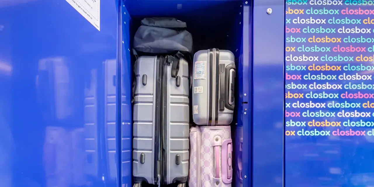 Luggage stored in a blue locker, including suitcases and bags.