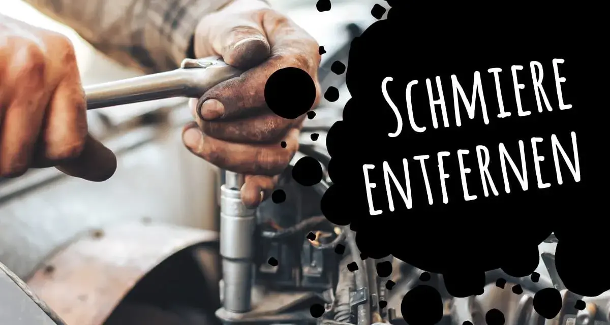 Hände mit Fettflecken reparieren ein Auto. Tipps, wie man Schmierfett aus Kleidung entfernen kann.
